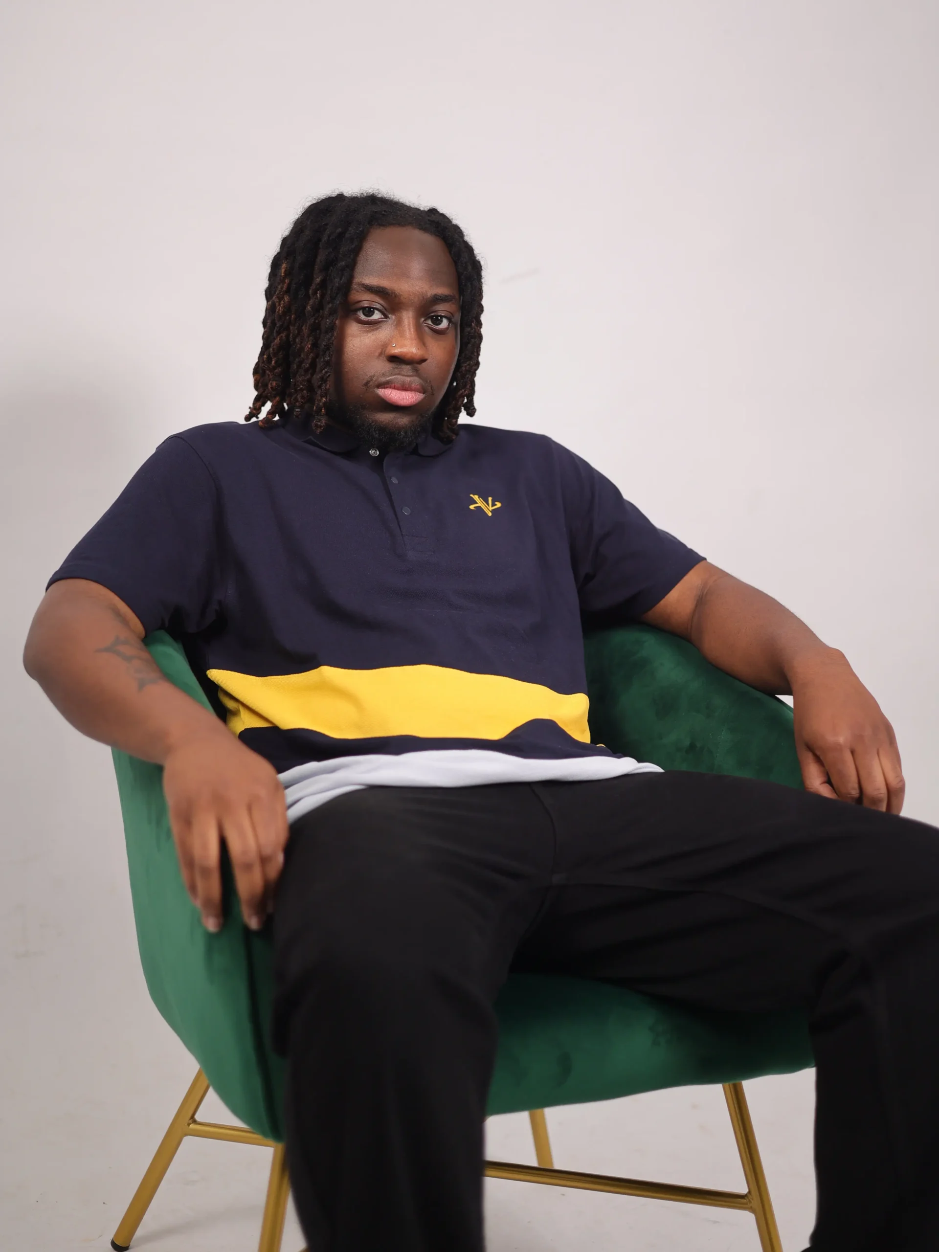 Man wearing Vizlen navy polo in a professional office lifestyle setting